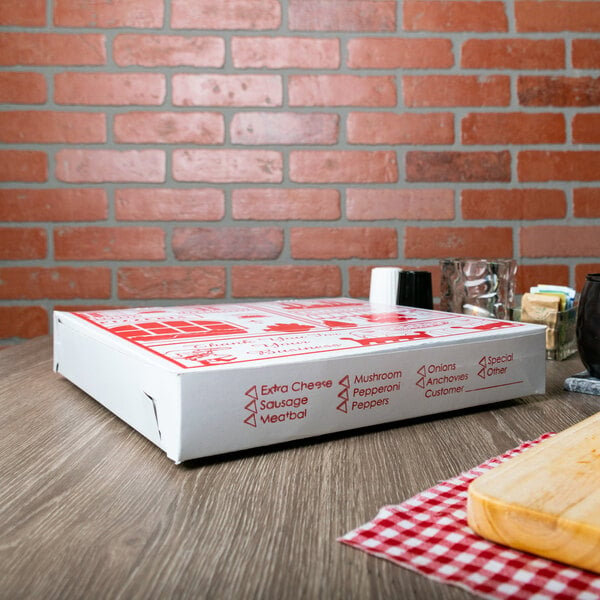 A white Choice pizza box with red labels on a table with food.