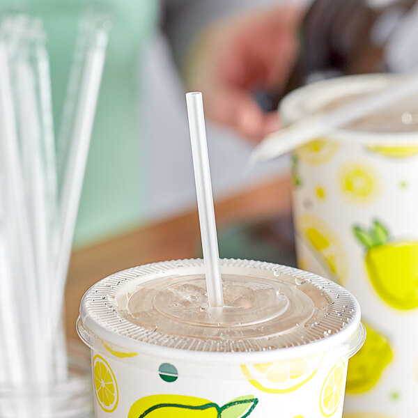 A cup of lemonade with a Choice jumbo translucent straw in it.