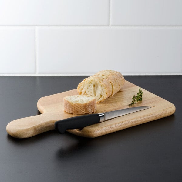 A Tablecraft bread board with a knife and a loaf of bread.