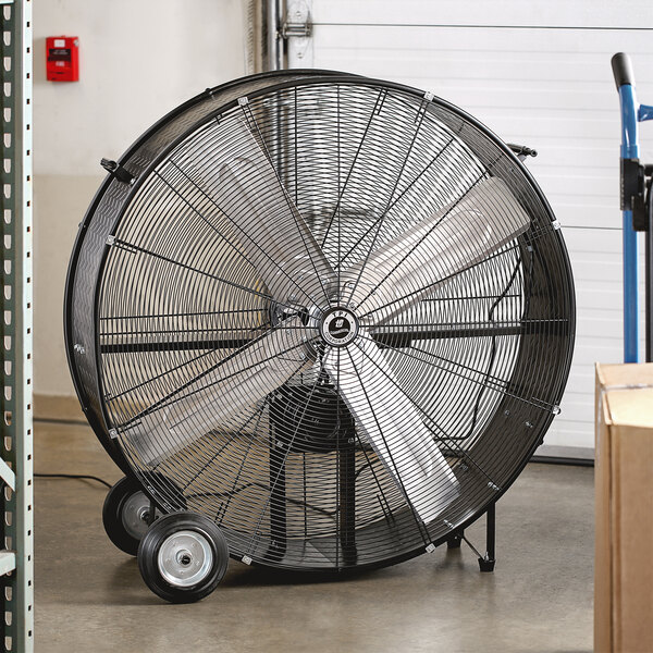 A large black TPI belt drive drum fan on wheels.
