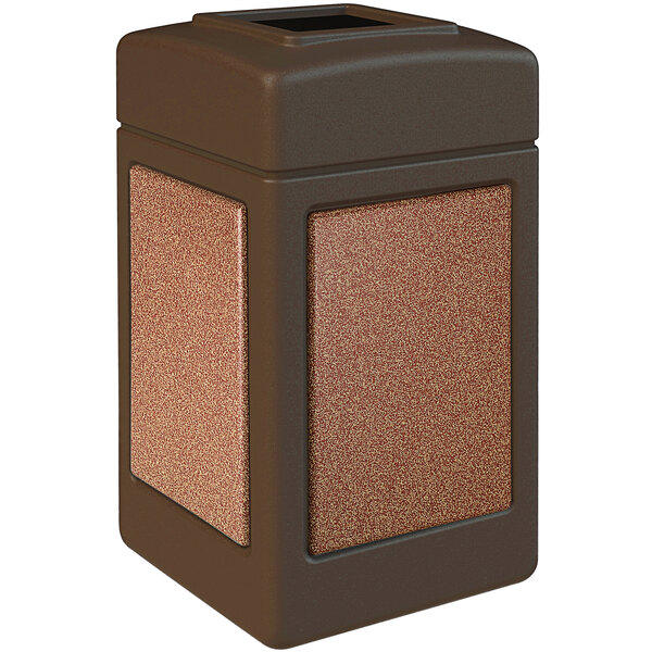 A brown stone-like square waste receptacle with brown Sedona panels.
