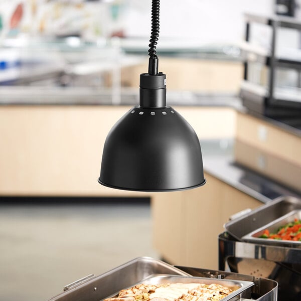 A black ServIt ceiling mount heat lamp hanging over a buffet table.