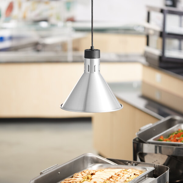 A tray of food under a ServIt stainless steel ceiling mount heat lamp.