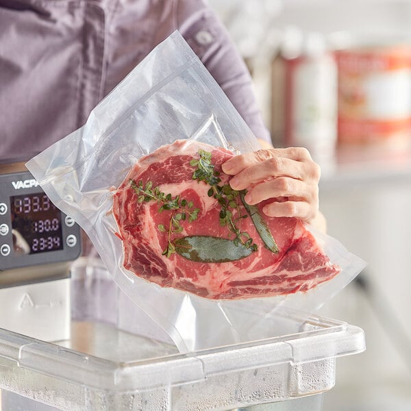 A person holding a piece of meat in a Choice vacuum packaging bag.