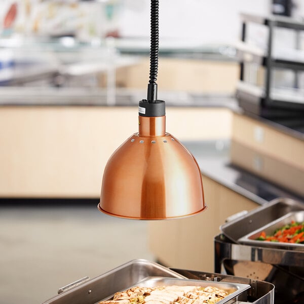 A ServIt copper ceiling mount heat lamp with a round dome shade over food.