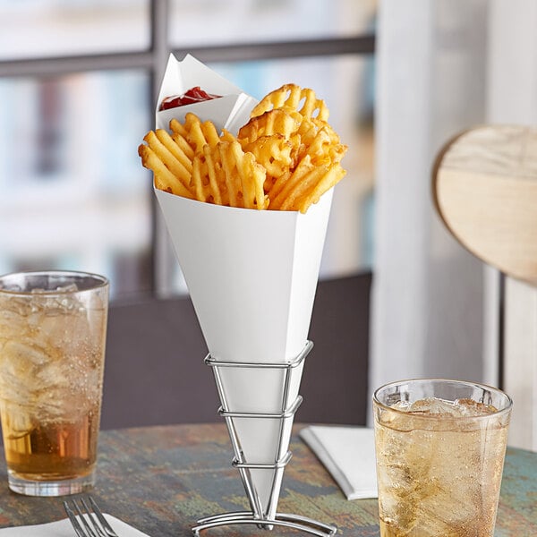 A Carnival King white cardboard fry cone filled with French fries sits on a table.