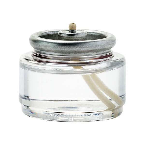 A glass jar with a metal lid and white liquid fuel cartridges inside.