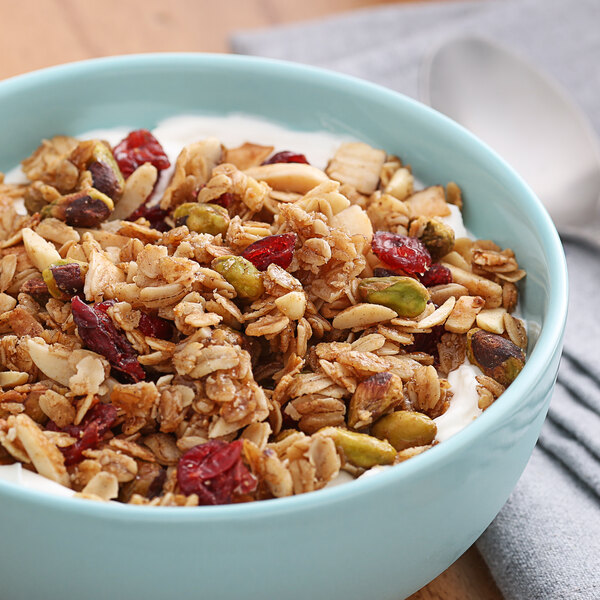 A bowl of oatmeal with nuts and cranberries.