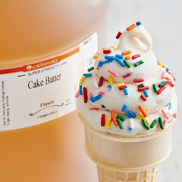A scoop of ice cream with sprinkles and a drizzle of LorAnn Oils Cake Batter flavoring.