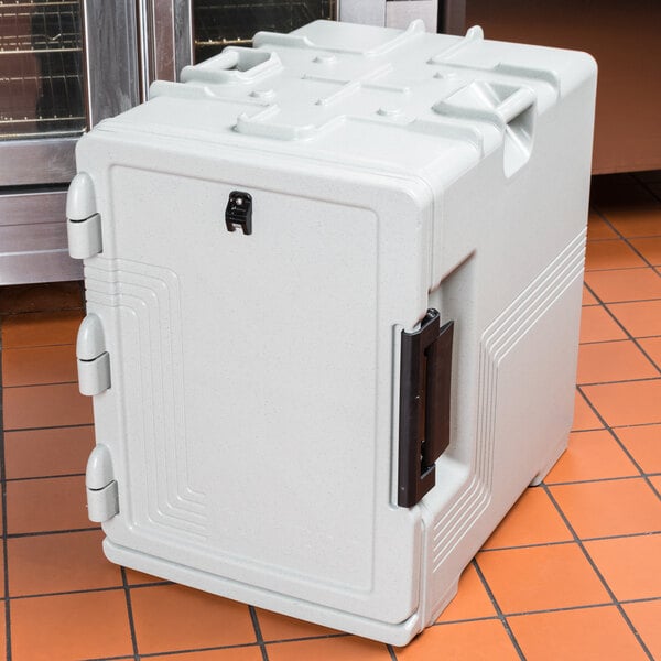 A speckled gray Cambro front-loading insulated food pan carrier on a tile floor.