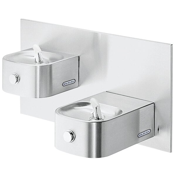 An Elkay stainless steel bi-level wall mount drinking fountain with two taps.