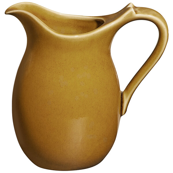 A RAK Porcelain caramel pitcher with a handle.