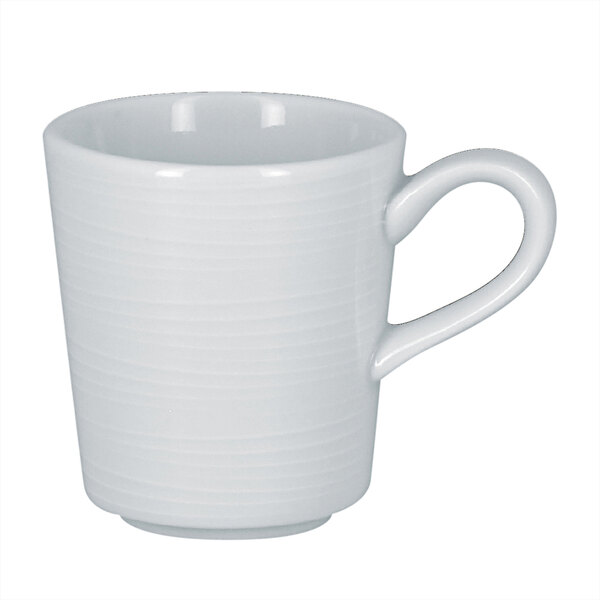A close-up of a RAK Porcelain bright white espresso cup with a handle.