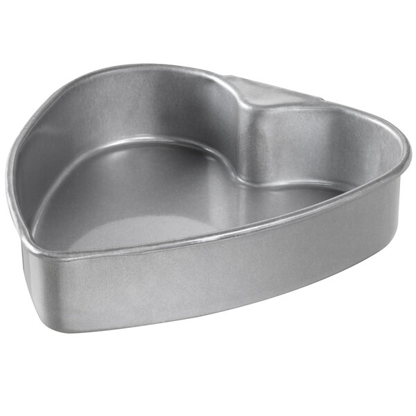 A Chicago Metallic heart shaped cake pan with a handle.
