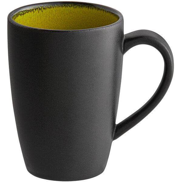 A black porcelain mug with a yellow rim and handle.