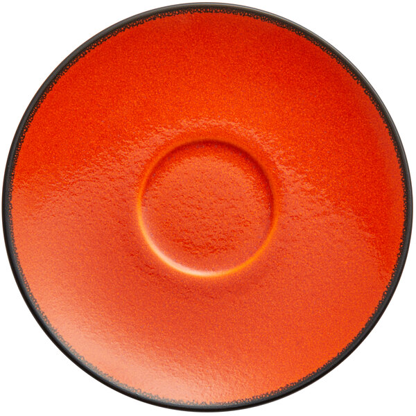 An orange RAK Porcelain saucer with a black border.