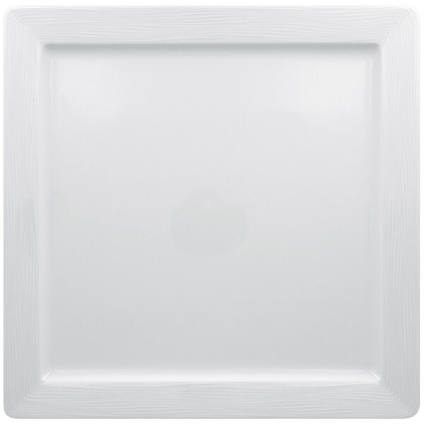 A white square porcelain plate with an embossed pattern around the rim.