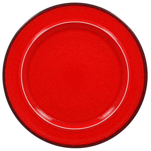 A red porcelain plate with a black rim.