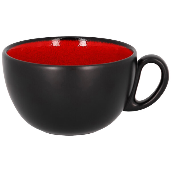 A red porcelain breakfast cup with a black handle.