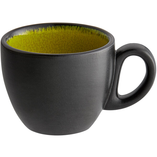 A green porcelain espresso cup with a handle.