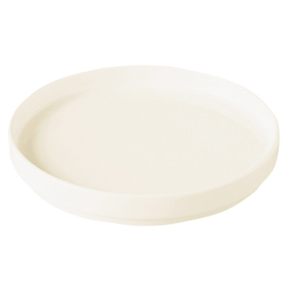 A RAK Porcelain warm white round porcelain plate with a rim.