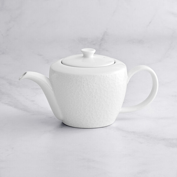 A RAK Porcelain bright white teapot with lid on a marble surface.