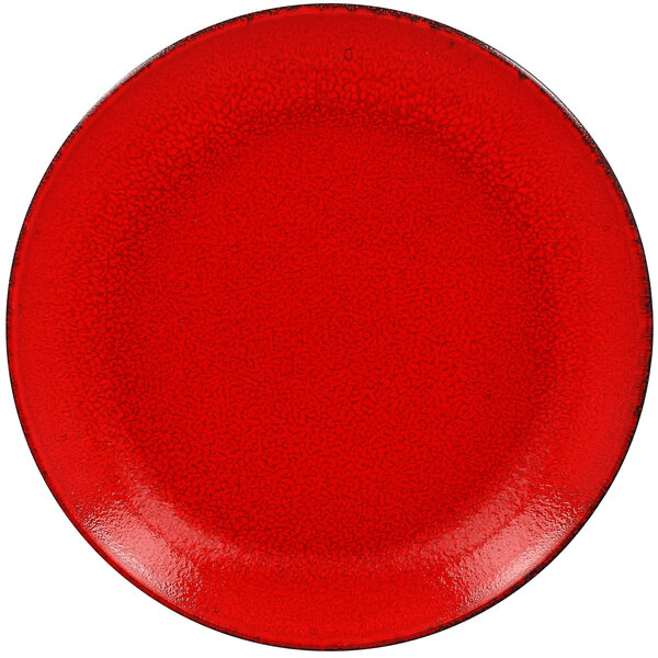 A red RAK Porcelain coupe plate with black speckled edges.