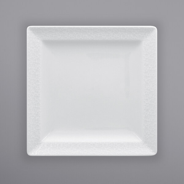 A RAK Porcelain bright white square porcelain plate with an embossed pattern.