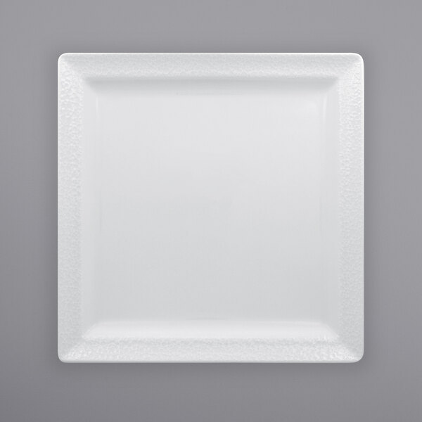 A white square RAK Porcelain plate with a textured surface.