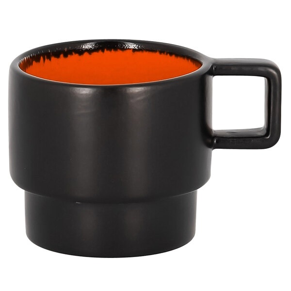A black porcelain espresso cup with an orange rim.
