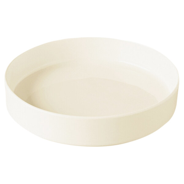 A RAK Porcelain warm white porcelain plate with a raised rim on a white surface.