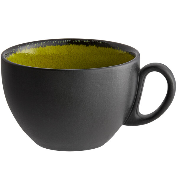 A green and black RAK Porcelain coffee cup with a handle.
