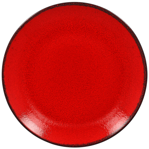 A white porcelain coupe plate with a red rim and black speckles.