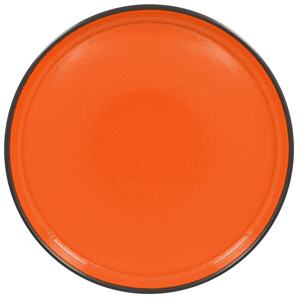 An orange RAK Porcelain deep porcelain plate with a black rim.