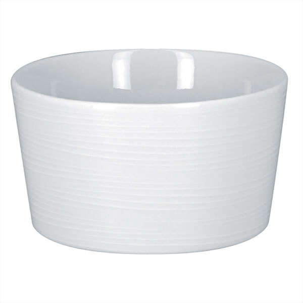 A bright white RAK Porcelain bouillon cup with an embossed design on a white background.
