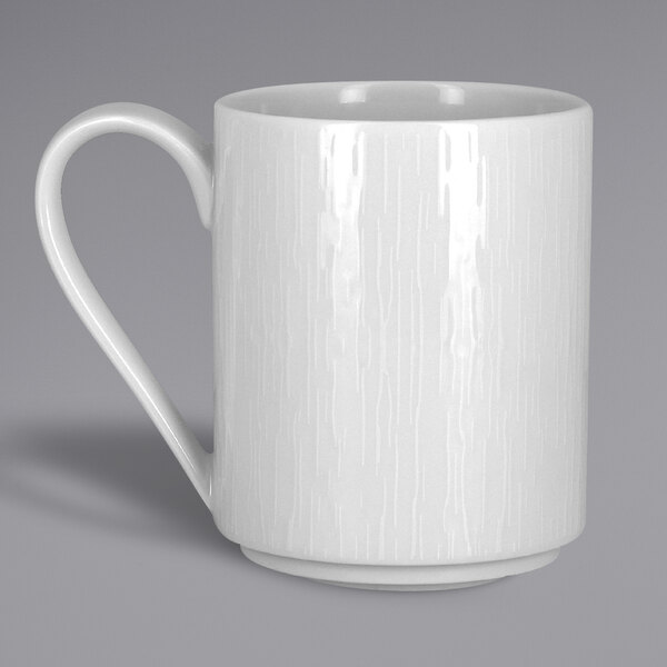A close-up of a RAK Porcelain Soul white porcelain mug with a handle.
