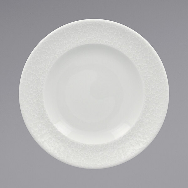 A RAK Porcelain bright white porcelain plate with a circular pattern on the rim.