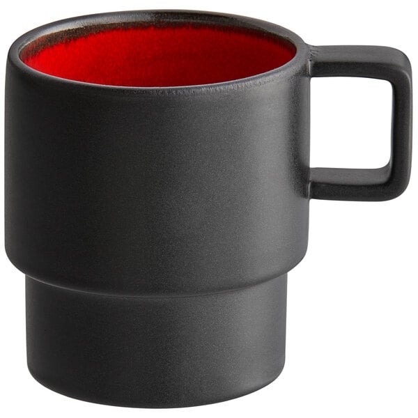 A black coffee cup with a red rim.