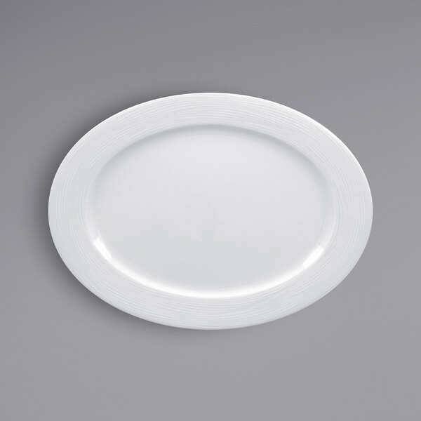 A white RAK Porcelain oval plate with an embossed white rim.