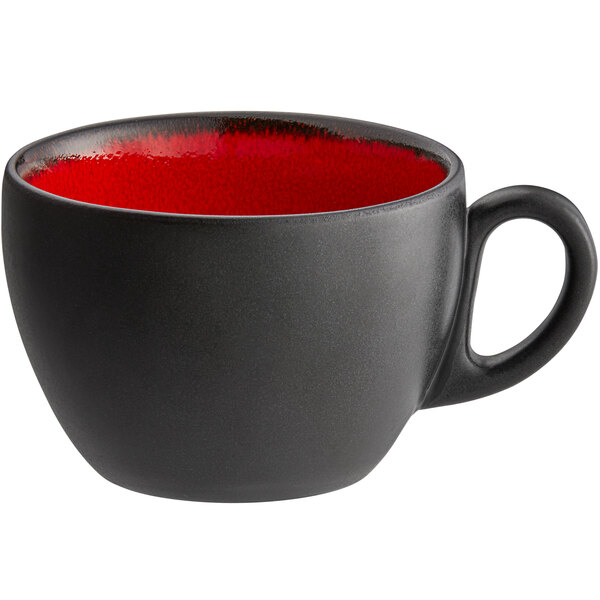 A red and black RAK Porcelain coffee cup with a handle.