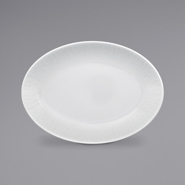 A bright white RAK Porcelain oval coupe platter with an embossed pattern.