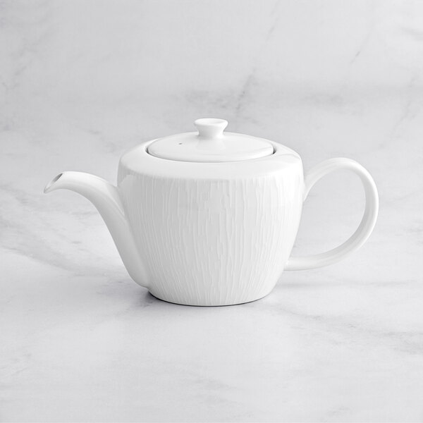 A RAK Porcelain bright white teapot with lid on a white surface.