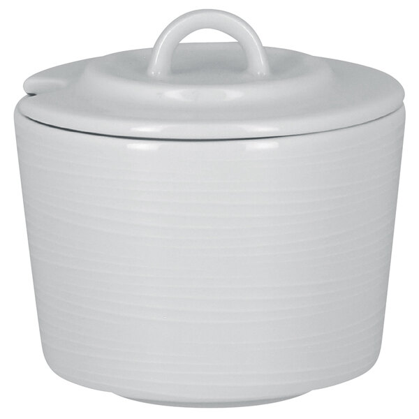 A RAK Porcelain bright white ceramic sugar bowl with a curved lid.