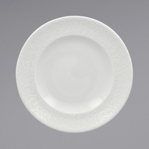A RAK Porcelain bright white porcelain plate with a textured pattern on the rim.