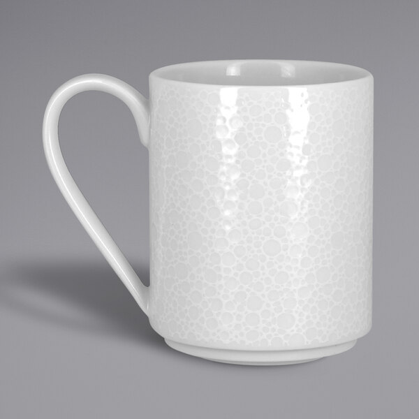 A close-up of a RAK Porcelain bright white mug with a handle.