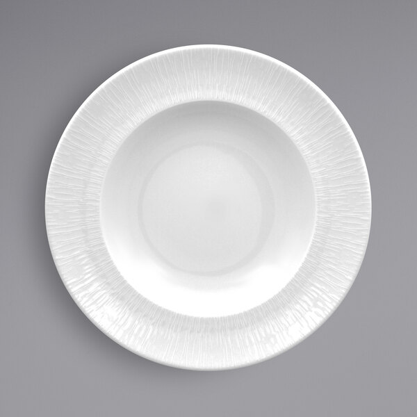 A RAK Porcelain white porcelain plate with an embossed white rim.