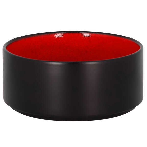 A black bowl with a red rim and black interior.