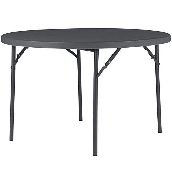 A ZOWN grey round folding table with legs.