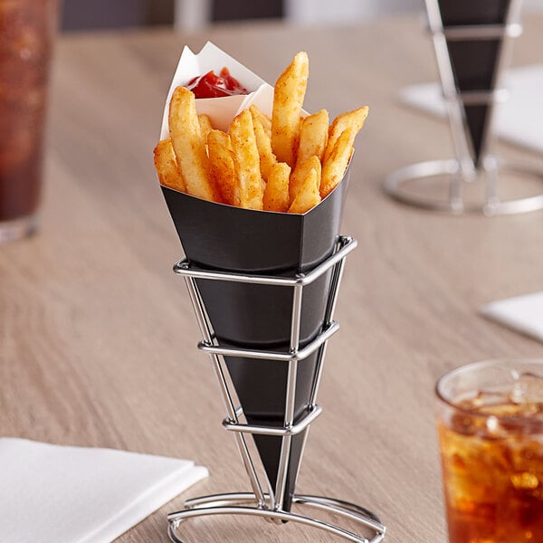A black Carnival King cardboard fry cone filled with french fries on a table.