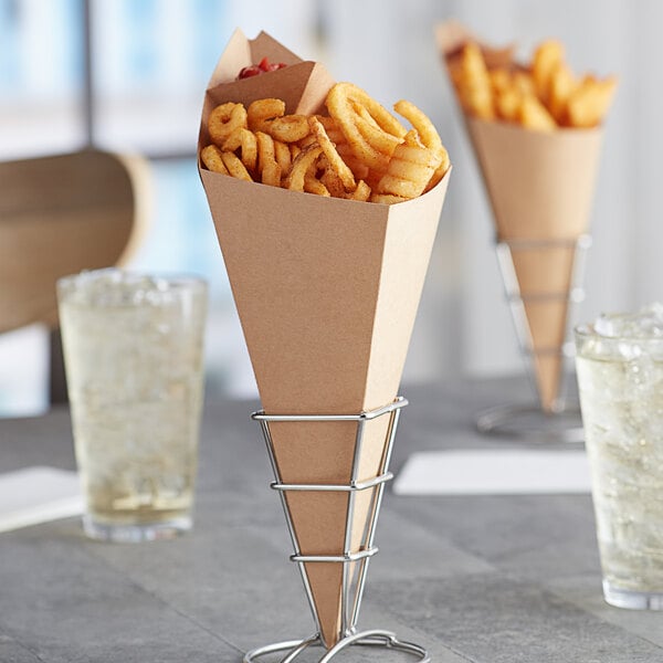 Two Carnival King Kraft cardboard cones filled with French fries on a table.
